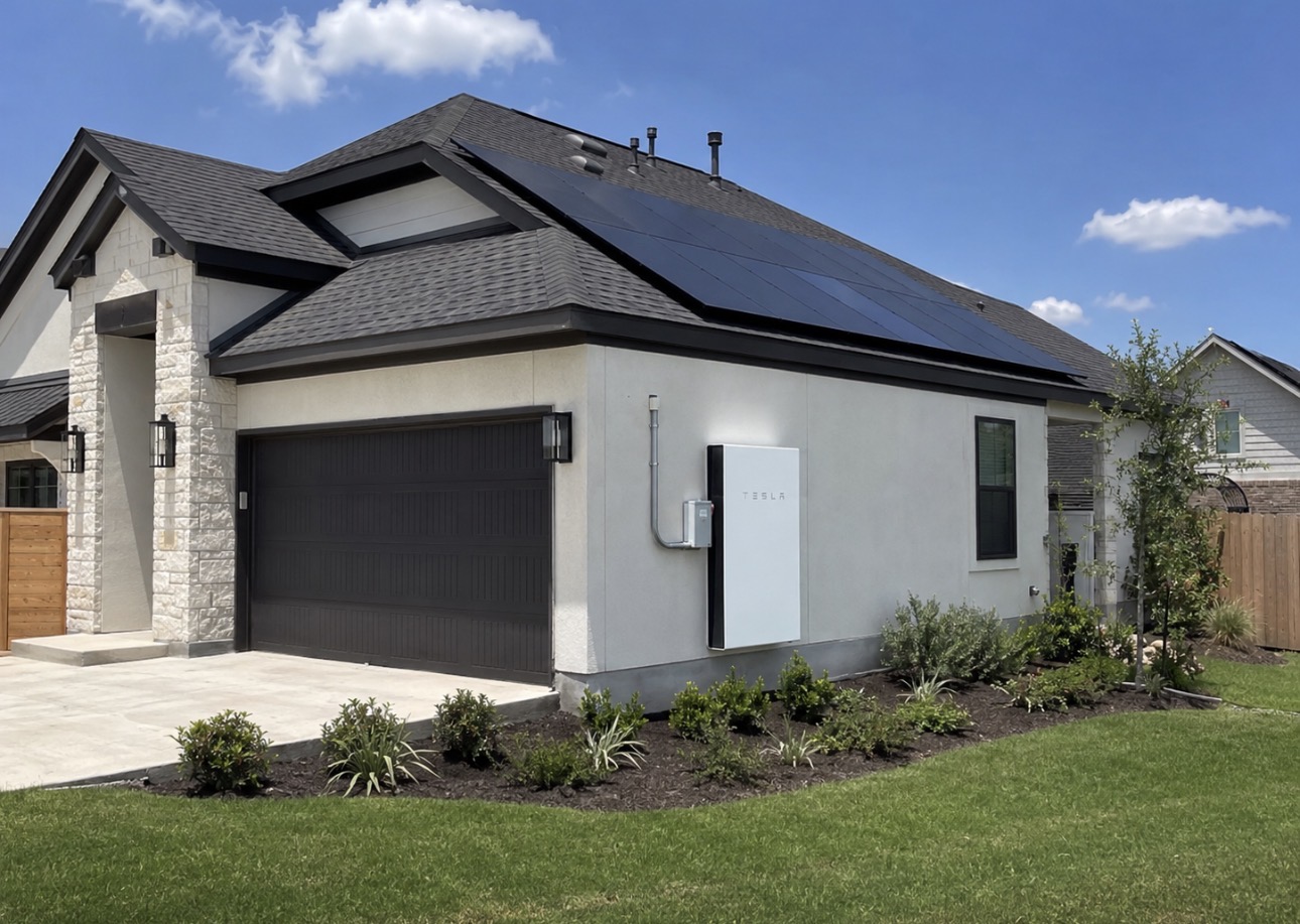 Texas home with rooftop solar and a Tesla Powerwall battery backup installed on the garage wall